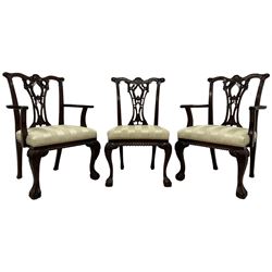 Set of eleven (9+2) Chippendale design mahogany dining chairs, the shaped cresting rail carved with central shell motif and scrolled foliage, pierced and foliate carved splat back, over-stuffed upholstered seats in striped pale fabric, gadroon carved seat rail, acanthus carved cabriole front supports with ball and claw feet, the carvers with extending arms with acanthus leaf carved terminals