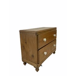 Victorian pine chest fitted with two deep drawers and ceramic pull handles, raised on turned supports W102cm, H87cm, D47cm 