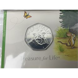 Four The Royal Mint United Kingdom brilliant uncirculated two pound coins and seven brilliant uncirculated fifty pence coins, each housed on card