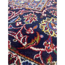 Fine Hand Knotted Persian Kashan carpet, the red field decorated with deep blues, greens and ivory and bordered 295cm x 390cm 