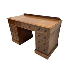 Maple & Co - Edwardian mahogany twin pedestal desk, rectangular top with raised back, fitted with central frieze drawer flanked by four graduating drawers, on castors
