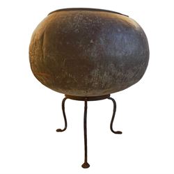 19th century globular copper chocolate pot or garden planter of large proportions, raised on a later wrought metal tripod stand with three shaped splayed supports with pad feet 