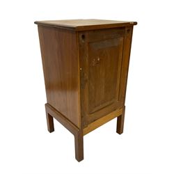 Late 19th century Arts & Crafts walnut bedside cupboard, rectangular moulded top over single drawer and panelled cupboard, with brass drop handles and stylised flower head plates, lower moulded edge over square feet, panelled back  