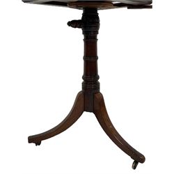 George III mahogany reading table, the rectangular hinged top with an adjustable ratchet support, flanked by twin pivotal pull-out candle slides, raised on a ring turned column pedestal terminating in a splayed support tripod base with brass castors