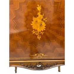 Italian marquetry inlaid walnut drinks cabinet, the doors with central satinwood floral cartouche inlay and extending star pattern parquetry, the maple interior with mirror back and central shelf over small drawers and pigeonholes, fitted with sliding tray and two long drawers, the carved and moulded apron with pierced C-scroll decoration and extending foliage, raised on cabriole supports
