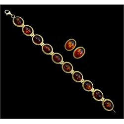 Gold oval link amber bracelet and pair of gold matching stud earrings, both hallmarked 9ct