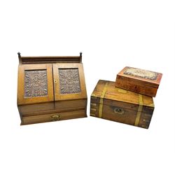 Edwardian oak correspondence box with two panelled doors carved with acanthus leaves below a raised back L37.5cm, H36cm, D22cm, Victorian mahogany writing slope with brass inlay, late 19th/ early 20th century tooled leather jewellery box with needlework top