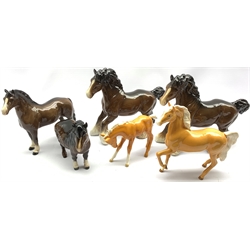 Six Beswick horses and foals including Two Cantering Shires in brown No. 975, Palomino foal No.947, Welsh Cob No. 1793 first version, Shetland Pony No. 1033 and a Palomino horse No. 1261 second version