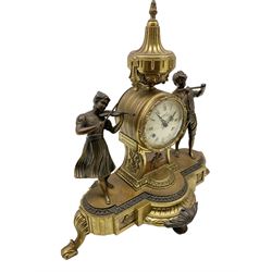 20th century - continental 8-day mantle clock, drum cased movement surmounted with a conical urn and flanked by two cast figures of young musicians, enamel dial with Roman numerals and gilt hands, twin train spring driven movement with a floating balance escapement, striking the hours and half hours (ting tang) on two bells. With key. 