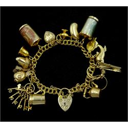 9ct gold double curb link bracelet, with heart locket clasp by Georg Jensen Ltd, with fifteen 9ct gold charms including keys, fish, acorn, money box, dolphin and cutlery set, all hallmarked