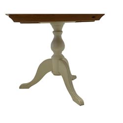 Painted pine breakfast table, circular top, raised on turned vasiform pedestal with reeded tripod base, the column in cream finish