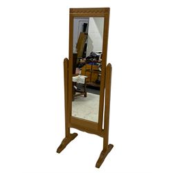 'Beaverman' oak cheval dressing mirror, the cresting rail carved with arcade, square supports with pointed finials on sledge feet carved with beaver signature, by Colin Almack of Sutton-under-Whitestonecliffe