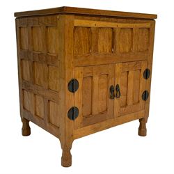 Yorkshire Oak - adzed oak side cabinet, the hinged top enclosing storage, all-over panelling and enclosed by two doors, on octagonal feet