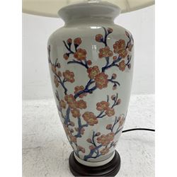 Pair of large table lamps of ovoid form, decorated with a peach blossom on plain ground, raised upon a circular base, H70cm