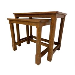 Rabbitman - oak nest of two tables with with rectangular tops, raised on octagonal supports united by plain stretchers, each carved with rabbit signature, by Peter Heap, Wetwang