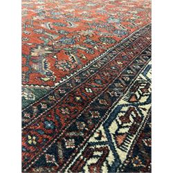Turkoman rug, the red field with all over floral design, surrounded by multiple borders 