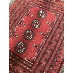 Small Persian rug of floral design, red field and bordered (140cm x 96cm) together with two small Bokhara rugs