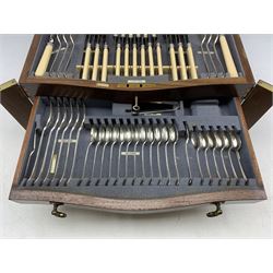 Canteen of rat tail pattern plated cutlery for twelve covers by Diss & Sons including bone handled knives, soup and sauce ladles 107 pieces, complete except knife rests missing, housed in a mahogany serpentine fronted table cabinet W47cm  