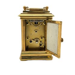 A contemporary miniature carriage clock with Sevres style porcelain panels, timepiece movement with a platform lever escapement, clock in a gilt case, with a white dial with Roman numerals, minute markers and steel moon hands, subsidiary day and date dials, with bevelled glass panels to the case and a rectangular glass panel to the top of the case. With Key.
