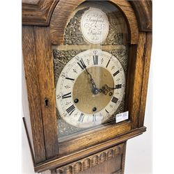 Mid-20th century “Grandmother” clock in a light oak case with a break arch top and conforming glazed hood door, with a stylised 18th century brass dial, spandrels, matted dial centre, silvered chapter ring and steel hands, case with a long trunk and applied carved detail on a short square plinth, with an eight-day three train spring driven Westminster chiming movement. With pendulum.  



