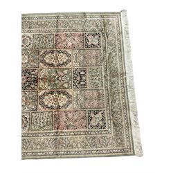 Indian design sage green ground rug, the field with various panels depicting Mirab motifs and foliate compositions with urn designs, the guarded border with repeating palmettes with stylised plant motifs