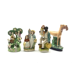  Staffordshire figure group in the style of Walton of male and female musicians in bocage H21cm, another of a standing greyhound holding a hare H25cm and two other Staffordshire figures   