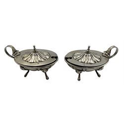 Pair Continental 800 standard silver salts of oval design with loop handles, clear glass liners and on four shaped supports