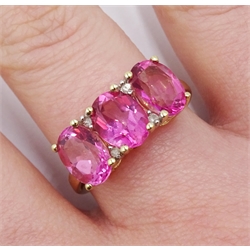 Gold three pink stone and diamond chip ring, stamped 9k