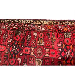Iranian Shahsavan magenta ground runner rug, the field decorated with all-over geometric designs and stylised plant motifs, the double-band border with matching decoration