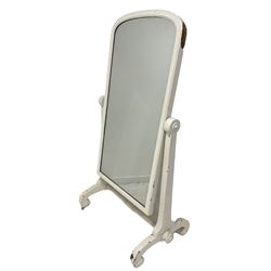 Victorian white painted mahogany cheval dressing mirror, the foxed arched swing mirror plate raised on square tapered uprights and scrolled supports with castors 