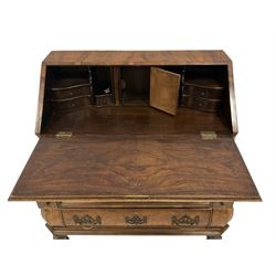 Early 20th century Dutch figured walnut bombe bureau, fall-front enclosing fitted interior with central cupboard flanked by pigeonholes and correspondence drawers with two secret drawers, over pen drawer stays and three graduating long drawers, lower moulded edge above ball and claw feet