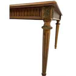 Regency style mahogany table, the moulded rectangular top with quarter veneers and boxwood stringing, fluted frieze with cast gilt metal leaf mounts, turned and fluted tapering supports