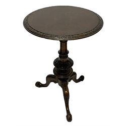 Victorian figured walnut tripod table, the circular top with quarter matched veneers and foliate carved edge, on turned and carved column, on three splayed and scrolled supports 