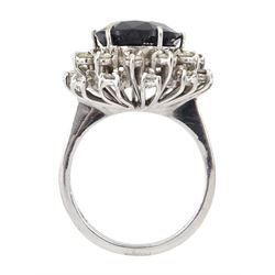 18ct white gold oval sapphire and round brilliant cut diamond cluster ring, London import marks 1978, sapphire approx 4.60 carat