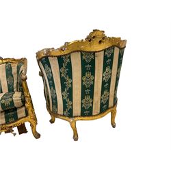 Pair Louis XVI design gilt framed armchairs, the cresting rail carved and moulded with central fleur-de-lis and extending foliate scrolls, scrolled arm terminals decorated with applied acanthus leaves, the apron with cartouche and pierced, raised on cabriole supports, upholstered in foliate patterned green and ivory striped fabric with sprung seat