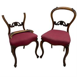 Set of six Victorian rosewood dining chairs, the balloon back carved with foliage scrolls, cartouche carved middle rail with extending scrolls, the seats upholstered in pink fabric, on carved cabriole supports with scrolled terminals 