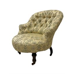 Victorian mahogany framed tub armchair, buttoned back and sprung seat upholstered in pale yellow ground foliate fabric, on turned front supports with castors