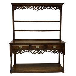 Georgian design oak dresser, the projecting cornice over two height plate rack to base, fitted with three drawers and pierced apron over pot board base 