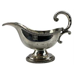 Small silver sauce boat with gadrooned edge, C scroll handle and short pedestal foot Sheffield 1917 Maker Jenkins & Timm