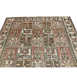 Persian Gabbeh Bakhtiari rose ground garden rug, the field decorated with square panels containing stylised palmette and urn motifs with floral symbols, the guarded border with repeating interlocking geometric shapes