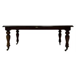 Victorian design mahogany extending dining table, rectangular top with moulded edge, raised on turned and lobed vasiform supports terminating in brass cups and castors, with additional leaf