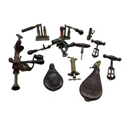 Various shotgun cartridge re-loading tools, two leather bodied powder flasks and three vintage corkscrews