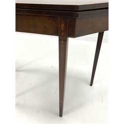 George III Sheraton style mahogany and boxwood strung tea table, the rectangular fold over top with canted corners over urn acorn and harebell inlays, raised on square tapered supports, W90cm