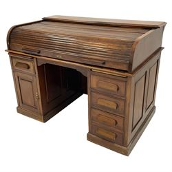 Late 19th century mahogany roll-top desk, tambour roll top over two panelled pedestals, fitted with two slides, four drawers and cupboard, plinth base
