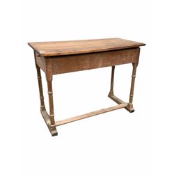 19th century limed oak clerks desk, the hinged angle adjustable top raised on four ring turned supports with sledge feet united by stretcher W102cm