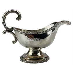Small silver sauce boat with gadrooned edge, C scroll handle and short pedestal foot Sheffield 1917 Maker Jenkins & Timm