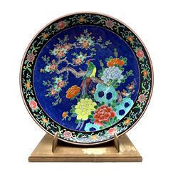 Late 19th/early 20th Century Japanese charger decorated with bird and flowering trees on a blue ground D46cm and with a later wooden stand