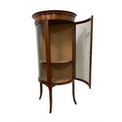 Edwardian inlaid mahogany bow-front display cabinet, projecting cornice with satinwood chequerboard  inlay over floral marquetry frieze with ebony stringing, single glazed door enclosing two shelves, raised on splayed supports