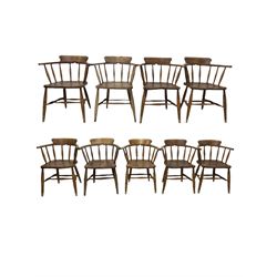 Set of nine early 20th century smokers chairs, the hooped and spindle back over elm seat, raised on turned supports, united by stretcher 