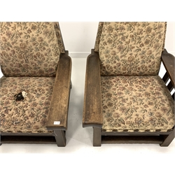 Two large early 20th century oak framed easy chairs, with moulded open arms, slatted sides, upholstered seat and back panel, raised on square supports, W84cm